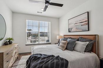 a bedroom with a bed and a ceiling fan  at Stella Luxury Apartment Homes, San Tan Valley, AZ, 85143